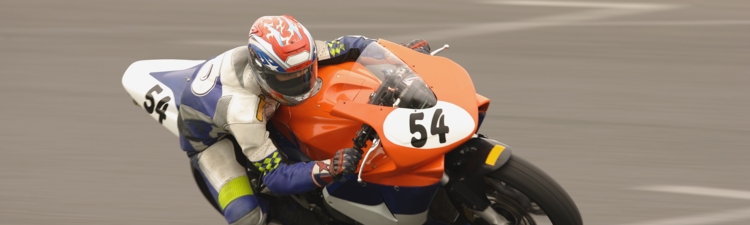 Racing motor bike cornering at speed