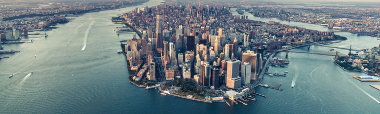 Image of the Manhattan skyline at sunset from an elevated angle.