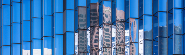 This view from Hill Street in downtown Los Angeles features reflections on the glass facade of the the First Street U.S. Courthouse.