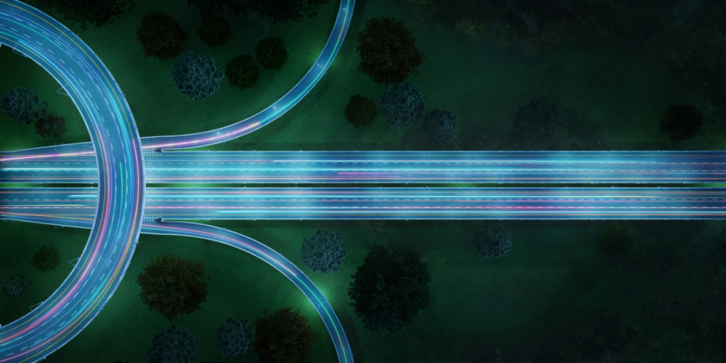 Aerial view of highway with car light trails at night. 3d rendering