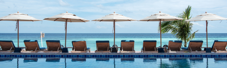 Wooden terrace beside tropical beach swimming pool