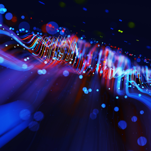 Digital generated image of abstract flowing data made out of glowing blue and red splines moving away from camera on black background.