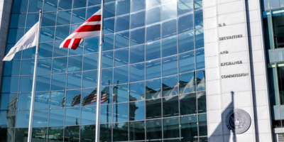 Washington DC, USA - October 12, 2018: United States Securities and Exchange Commission SEC architecture closeup with modern building sign and logo with red flags by glass windows