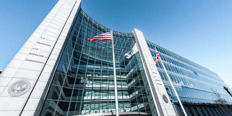 Washington DC, USA - January 13, 2018: US United States Securities and Exchange Commission SEC entrance architecture modern building sign, entrance, american flag, looking up sky, glass windows reflection