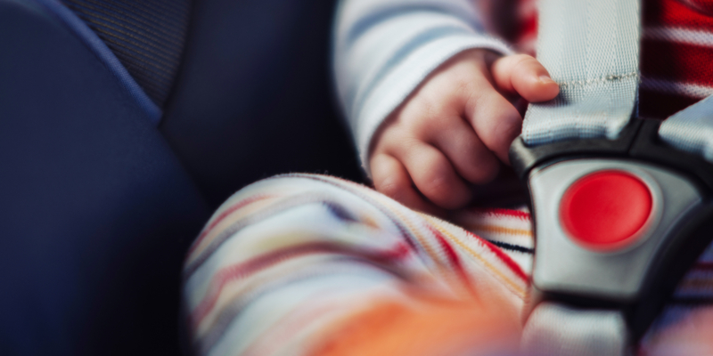 Baby in car seat, close up.