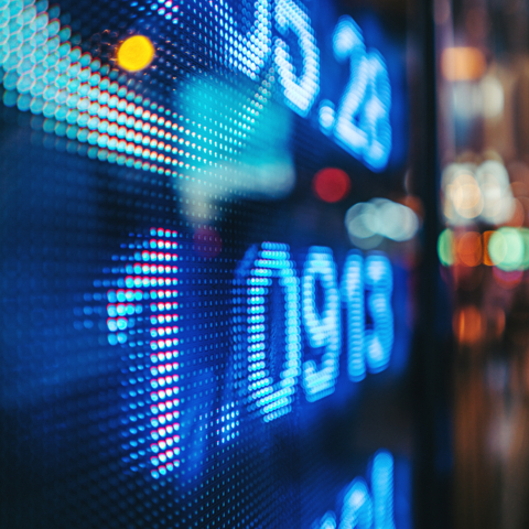 display stock market numbers with defocused street lights background 