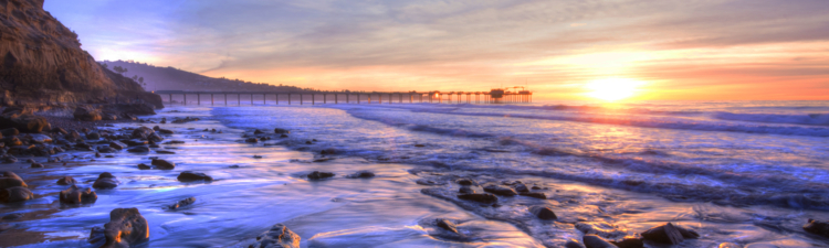 Colorfully vivid scenic southern California beach featuring Scripps pier in La Jolla at sunset with beautiful relfections